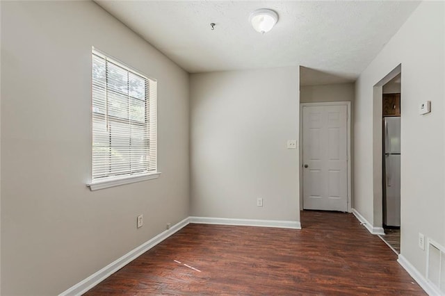 empty room with wood finished floors and baseboards