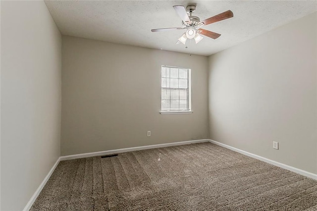 empty room with carpet floors, a ceiling fan, baseboards, and a textured ceiling
