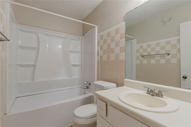 full bathroom with toilet, tile walls, bathtub / shower combination, and vanity