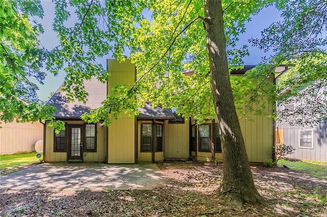 back of property with a shingled roof