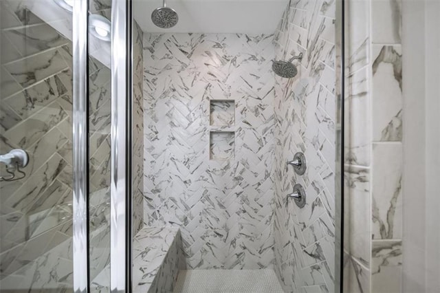 full bath featuring a marble finish shower