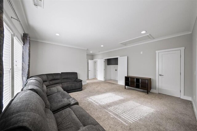 living area featuring baseboards, carpet floors, attic access, recessed lighting, and crown molding