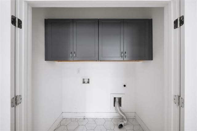 clothes washing area featuring cabinet space, electric dryer hookup, hookup for a washing machine, and baseboards