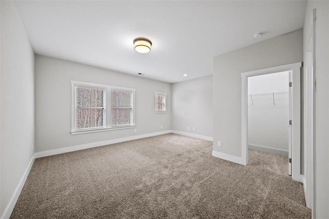 spare room with baseboards and carpet