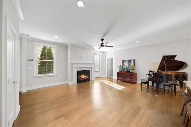 living room with recessed lighting, light wood-type flooring, baseboards, and ornamental molding