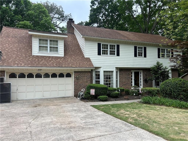 3798 Lee Ridge Way SW, Lilburn, GA 30047 - view of front of home with concrete driveway, brick siding, a chimney, and a shingled roof