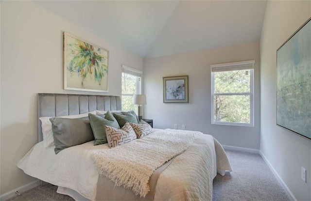 bedroom featuring carpet flooring, baseboards, and lofted ceiling