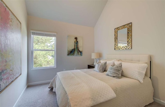 carpeted bedroom featuring baseboards and lofted ceiling