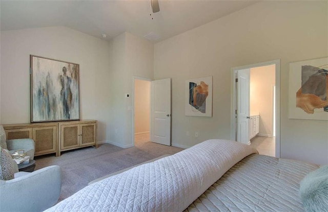 carpeted bedroom with ensuite bathroom, baseboards, a ceiling fan, and lofted ceiling