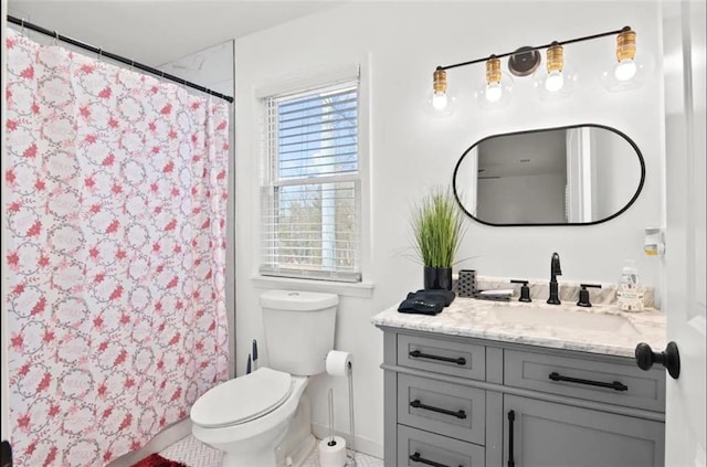 bathroom featuring vanity, toilet, and curtained shower