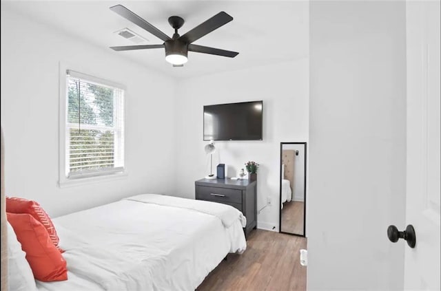 bedroom with ceiling fan and hardwood / wood-style floors