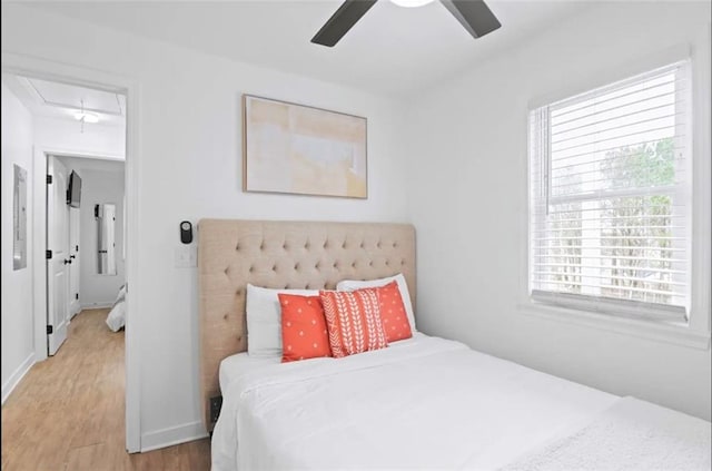 bedroom with wood-type flooring and ceiling fan