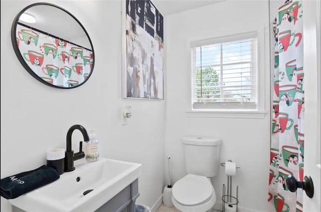 bathroom featuring vanity, toilet, and walk in shower