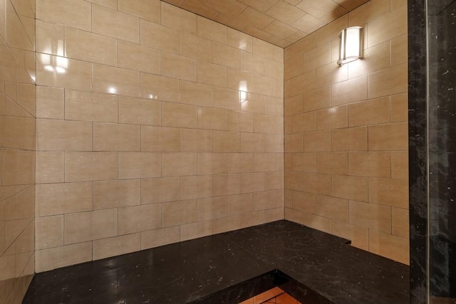 bathroom with a tile shower