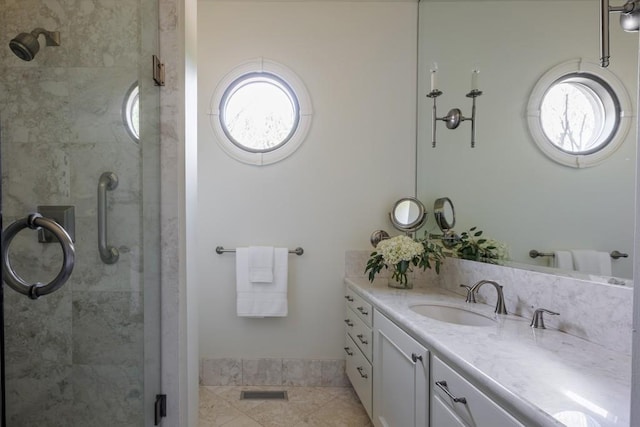 bathroom with tile patterned floors, vanity, and an enclosed shower