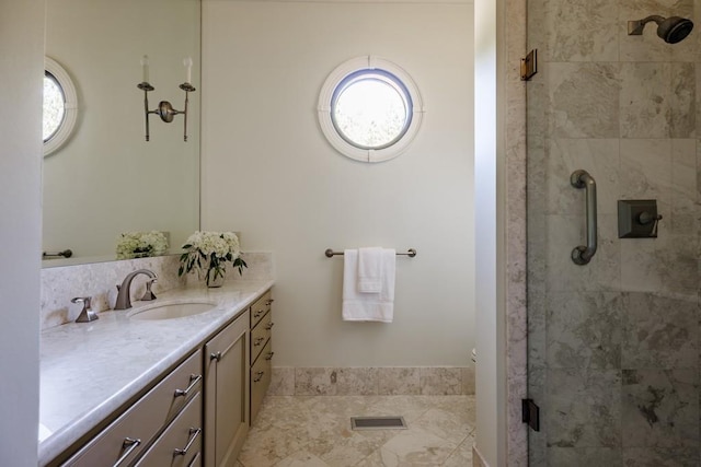 bathroom featuring vanity and an enclosed shower