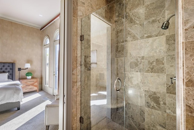 bathroom featuring a shower with shower door and ornamental molding