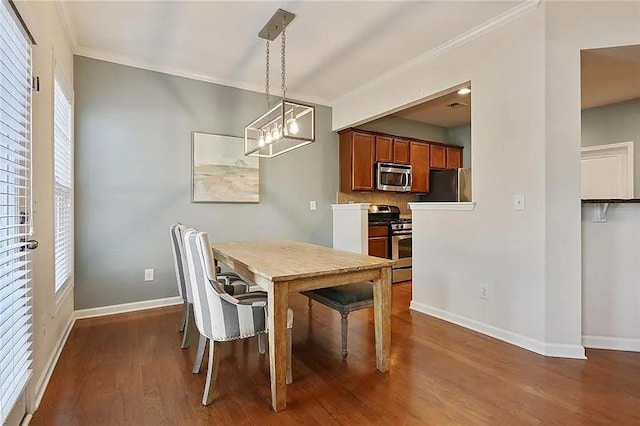 dining space featuring crown molding, dark wood-type flooring, and baseboards