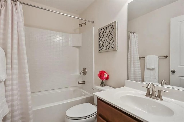 bathroom featuring vanity, toilet, and shower / bath combo with shower curtain