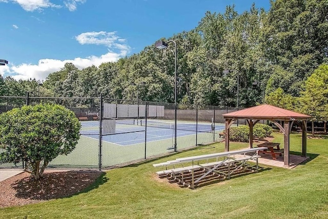 view of sport court with a gazebo, a yard, and fence