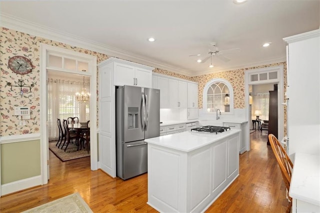 416 Mcdaniel St, Monroe, GA 30655 - kitchen featuring stainless steel fridge with ice dispenser, wallpapered walls, light countertops, ornamental molding, and light wood-style flooring