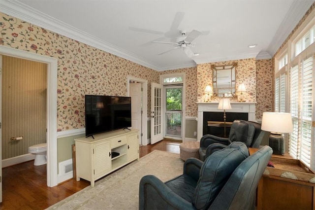 416 Mcdaniel St, Monroe, GA 30655 - living room featuring wallpapered walls, crown molding, wood finished floors, a ceiling fan, and a fireplace
