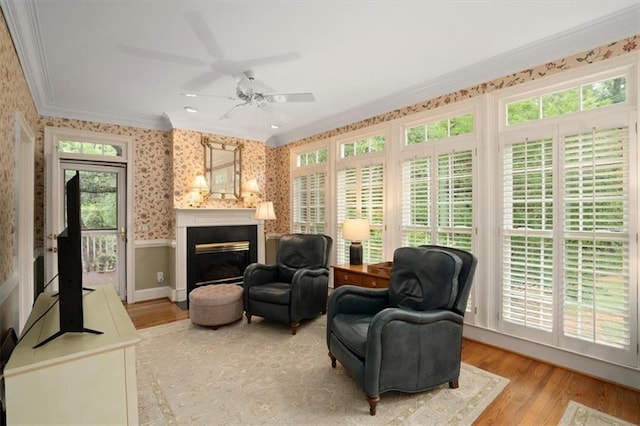 416 Mcdaniel St, Monroe, GA 30655 - sitting room featuring ornamental molding, wallpapered walls, plenty of natural light, a wainscoted wall, and light wood-style floors