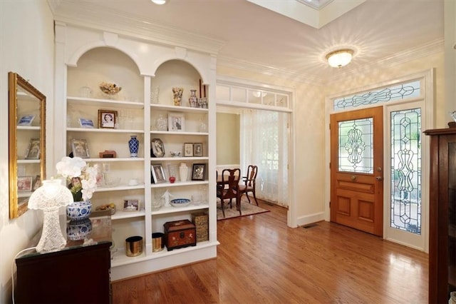 416 Mcdaniel St, Monroe, GA 30655 - foyer featuring wood finished floors, ornamental molding, and healthy amount of natural light