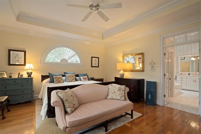 416 Mcdaniel St, Monroe, GA 30655 - bedroom featuring light wood-style flooring, crown molding, a tray ceiling, connected bathroom, and ceiling fan