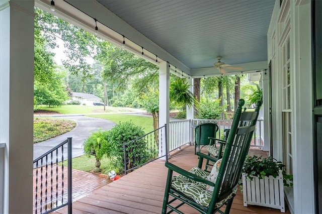 416 Mcdaniel St, Monroe, GA 30655 - wooden porch with a ceiling fan and view of wooded area