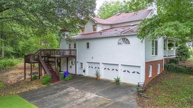 416 Mcdaniel St, Monroe, GA 30655 - rear view of property featuring driveway, an attached garage, stairs, a wooden deck, and brick siding