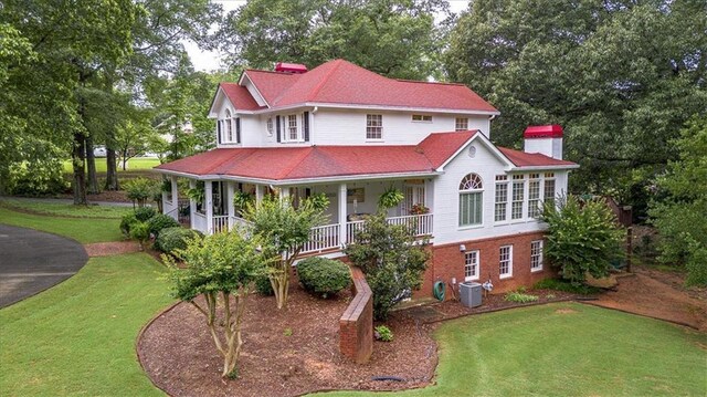 416 Mcdaniel St, Monroe, GA 30655 - view of front of property featuring a front lawn, covered porch, a chimney, and view of scattered trees
