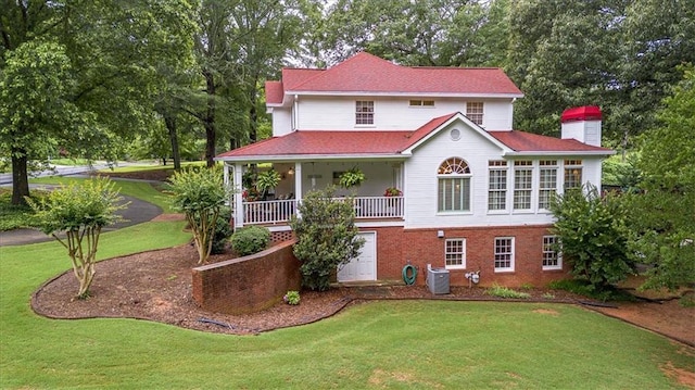 416 Mcdaniel St, Monroe, GA 30655 - view of front of home featuring a front lawn, a chimney, view of wooded area, and central air condition unit