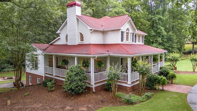 416 Mcdaniel St, Monroe, GA 30655 - farmhouse-style home with a chimney, covered porch, roof with shingles, and a front lawn