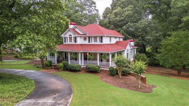 416 Mcdaniel St, Monroe, GA 30655 - view of front of home with a front yard, a porch, and a chimney