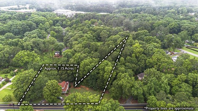 416 Mcdaniel St, Monroe, GA 30655 - aerial view of property and surrounding area with property boundaries highlighted and a heavily wooded area
