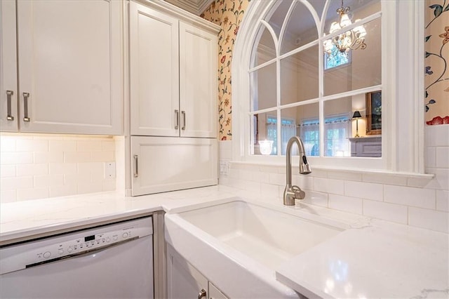 416 Mcdaniel St, Monroe, GA 30655 - kitchen featuring dishwasher, a sink, wallpapered walls, tasteful backsplash, and light stone counters