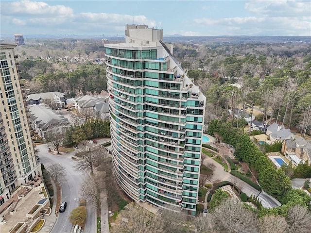 view of building exterior featuring a wooded view