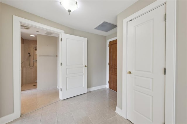 unfurnished bedroom with light tile patterned flooring and baseboards
