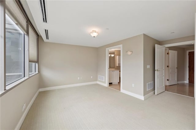 empty room with light carpet and baseboards