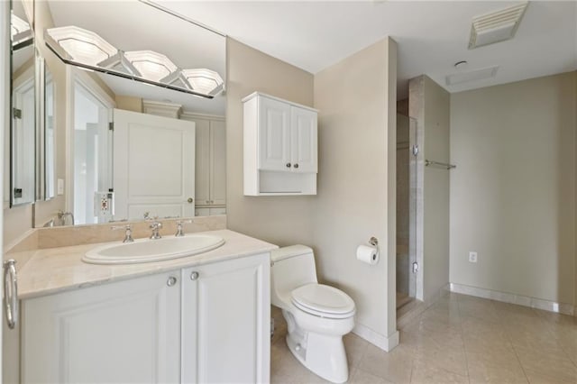 bathroom with toilet, tile patterned flooring, baseboards, and vanity
