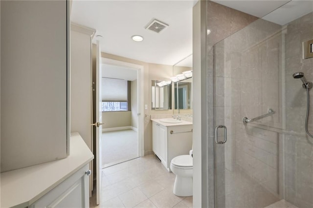 full bathroom with a stall shower, vanity, toilet, tile patterned floors, and baseboards