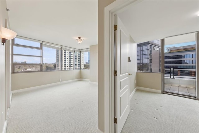 carpeted spare room with baseboards