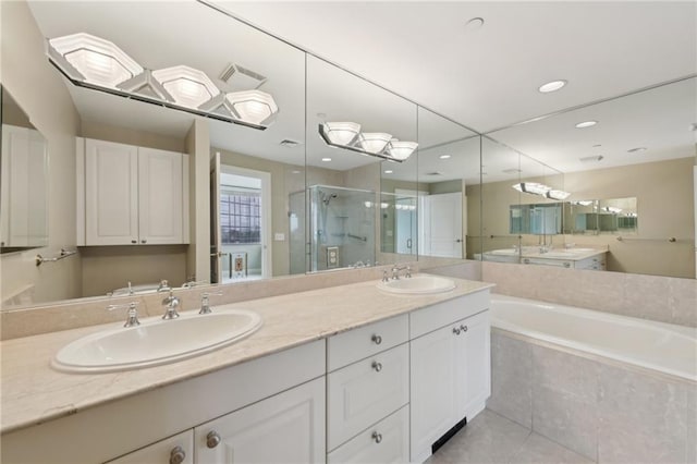 full bathroom with a stall shower, a garden tub, double vanity, tile patterned floors, and recessed lighting