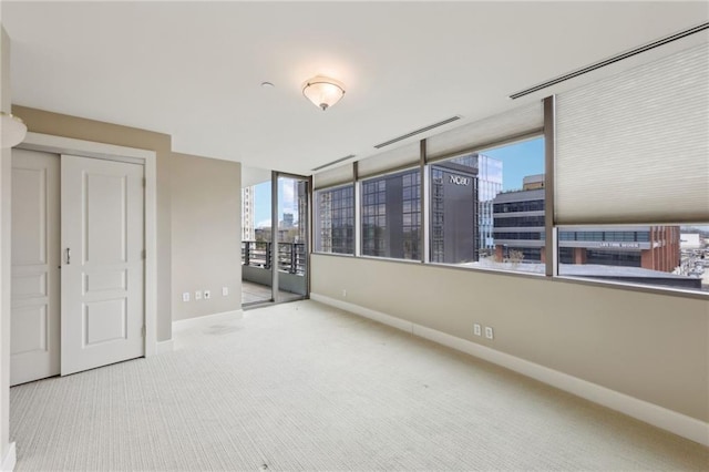 carpeted empty room with baseboards