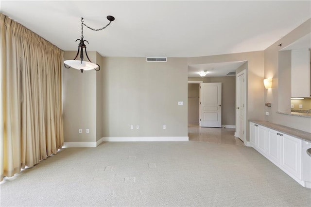 empty room with baseboards and light carpet