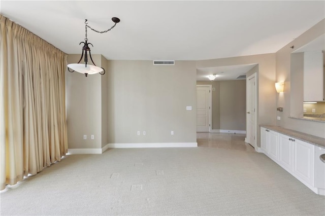 empty room with baseboards and light carpet