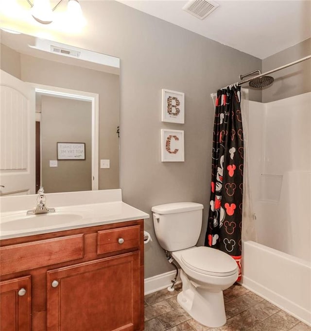 full bathroom with vanity, shower / tub combo, and toilet