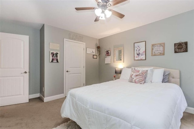 bedroom featuring light carpet and ceiling fan