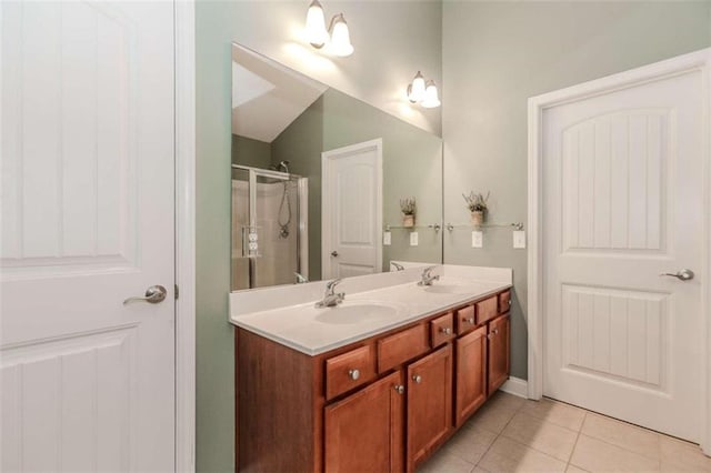 bathroom with tile patterned floors, vanity, and a shower with shower door